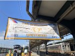 This is the banner honoring NJ Transit Rail Operationss 40th Anniversary. In the background on the left, we have the back of U34CH # 3372 as well as the Lackawanna MU car. 